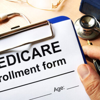 Medicare,Enrollment,Form,In,A,Hand.